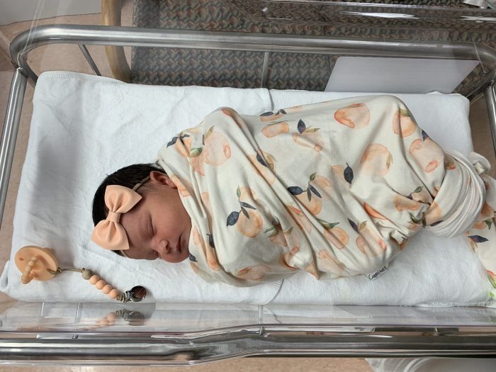 Baby girl sleeping in hospital crib